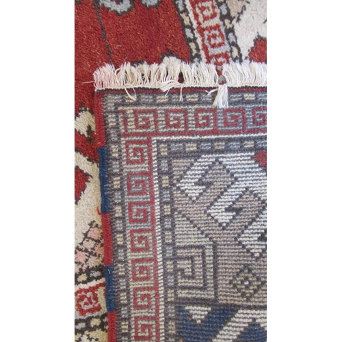 583 - A large hand knotted wool rug - 295cm x 208cm