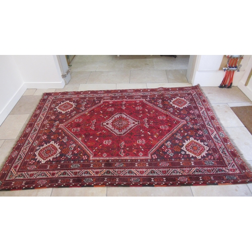 584 - A large red ground hand knotted Persian rug - 294cm x 210cm