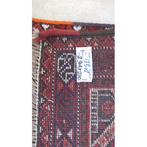 584 - A large red ground hand knotted Persian rug - 294cm x 210cm