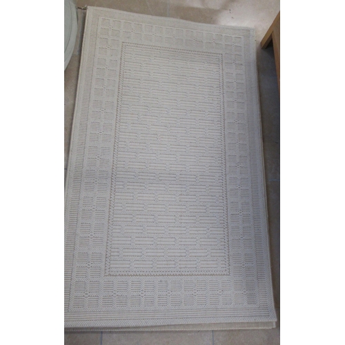 599 - Three cream woollen rugs - 152cm x 90cm - in good condition