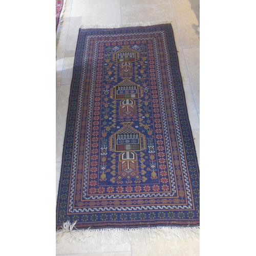 600 - A hand knotted rug with a blue field - 200cm x 103cm