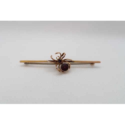 219 - A 9ct yellow gold (hallmarked) spider bar brooch with amethyst - 7cm - weight approx 4.5 grams