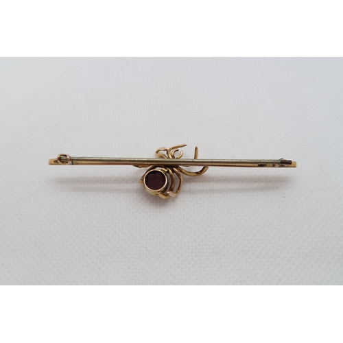 219 - A 9ct yellow gold (hallmarked) spider bar brooch with amethyst - 7cm - weight approx 4.5 grams