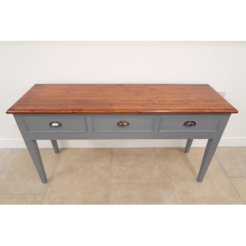 558 - A painted pine three drawer dresser base with a stained top - Width 163cm x Depth 49cm x Height 86cm... 