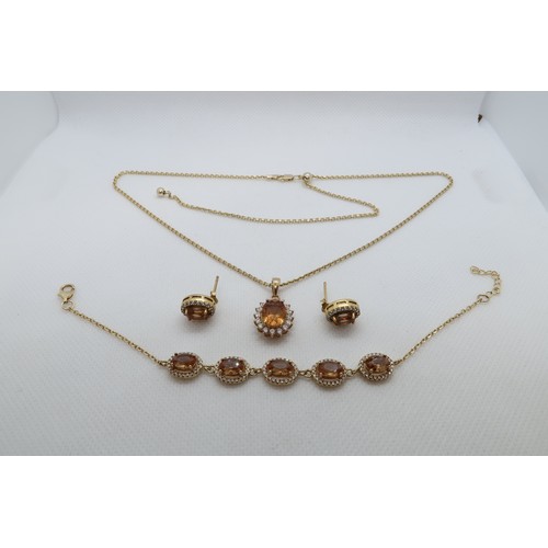 229 - A silver gilt jewellery suite with citrine pendant on chain, bracelet, ear studs