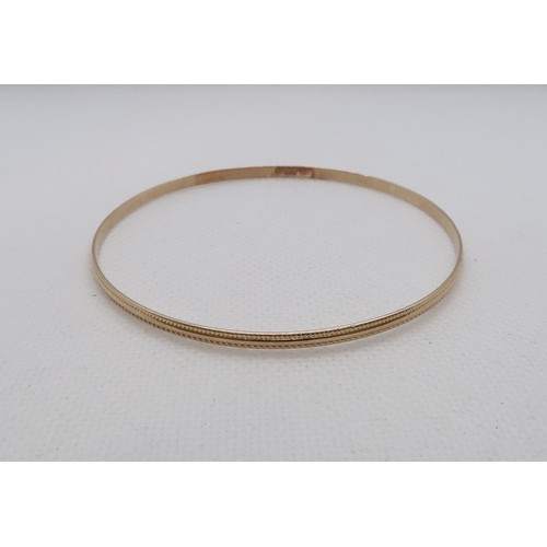 166 - An 18ct (hallmarked) yellow gold bangle - Diameter 6.5cm - approx weight 6.7 grams