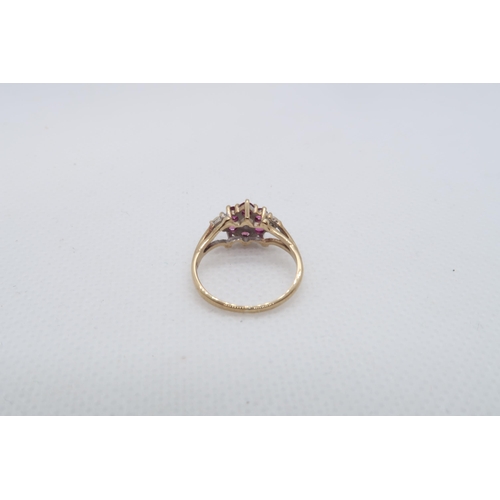 135 - A 9ct yellow gold (hallmarked) ruby and diamond cluster ring size I/J - approx weight 1.8 grams