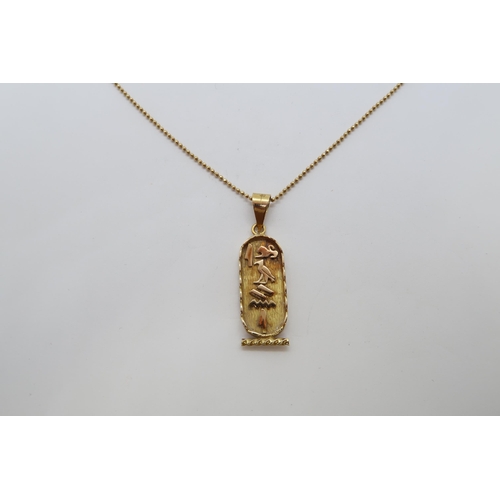 114 - An Egyptian 18ct (hallmarked) yellow gold pendant, 3cm, on 18ct (hallmarked) yellow gold chain - 50c... 