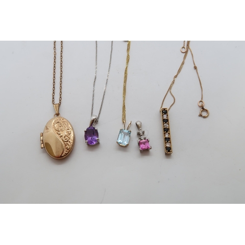 125 - Five 9ct (hallmarked) pendants on chains, various - weight approx 8.1 grams