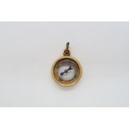 132 - An approx 18ct (tested) fob / charm as a compass, 1.8cm, approx 5.4 grams