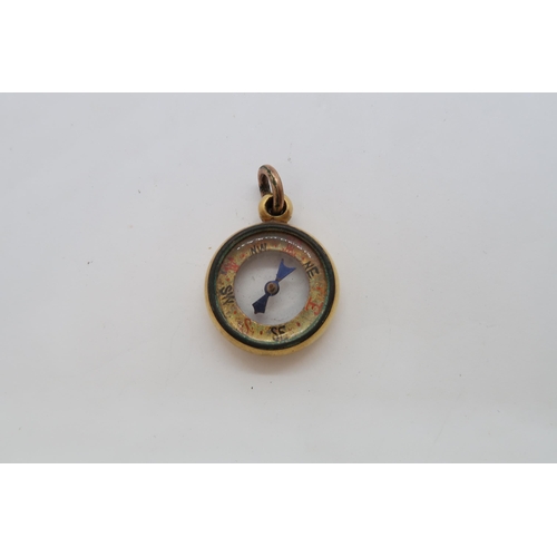 132 - An approx 18ct (tested) fob / charm as a compass, 1.8cm, approx 5.4 grams