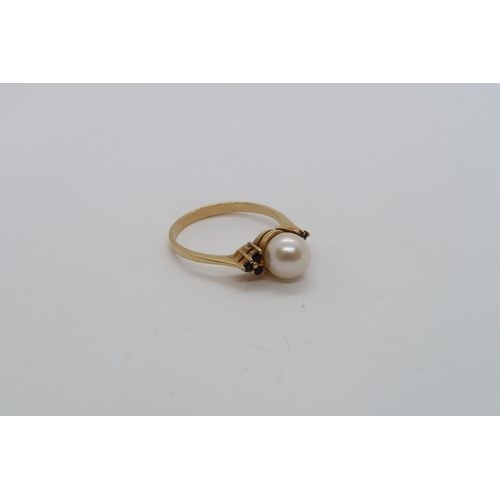 144 - An 18ct hallmarked yellow gold ring with central pearl triple setting sapphire shoulders, size L, ap... 