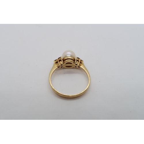 144 - An 18ct hallmarked yellow gold ring with central pearl triple setting sapphire shoulders, size L, ap... 