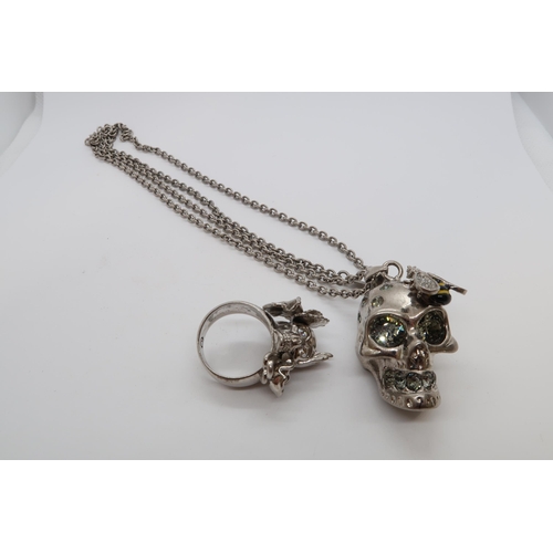 155 - An Alexander McQueen skull pendant on chain, pendant 3cm, together with an Alexander McQueen ring, s... 