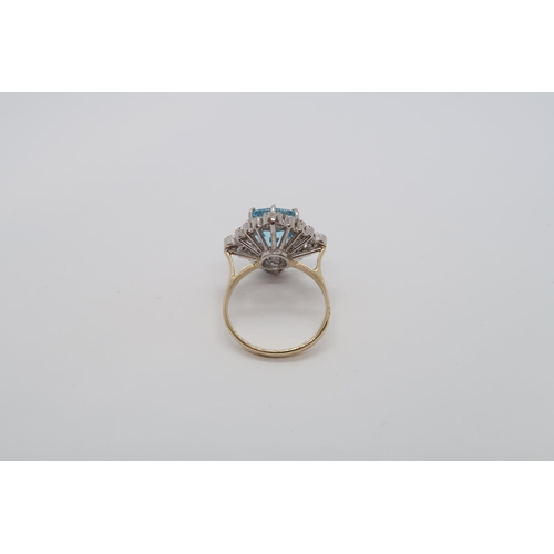 159 - A 9ct white and yellow gold vintage style ring set with a large cushion cut blue topaz and round bri... 