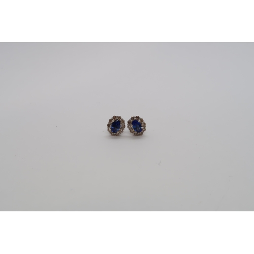 164 - A pair of 18ct white gold sapphire and diamond scalloped stud earrings, boxed - oval sapphires 0.60c... 