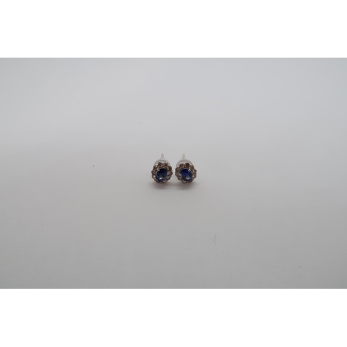 164 - A pair of 18ct white gold sapphire and diamond scalloped stud earrings, boxed - oval sapphires 0.60c... 