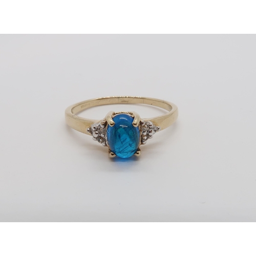 169 - A 9ct yellow gold cabochon neon apatite ring with diamond shoulders - ring size Q