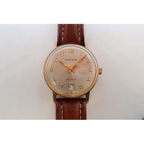 251B - A gents 9ct gold cased Garrard Automatic wristwatch - case 33mm - with date aperture at 6 - working ... 