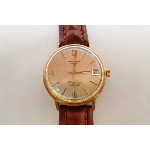 255A - A gents 9ct gold cased Longines Flagship automatic wristwatch - case 34mm - with date aperture - wor... 