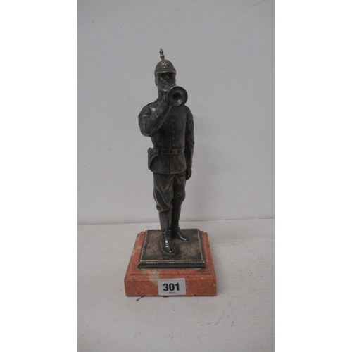 301 - A silver (tested) figure of a soldier with bugle on stone base - 27cm