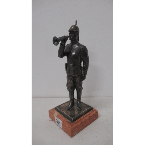 301 - A silver (tested) figure of a soldier with bugle on stone base - 27cm