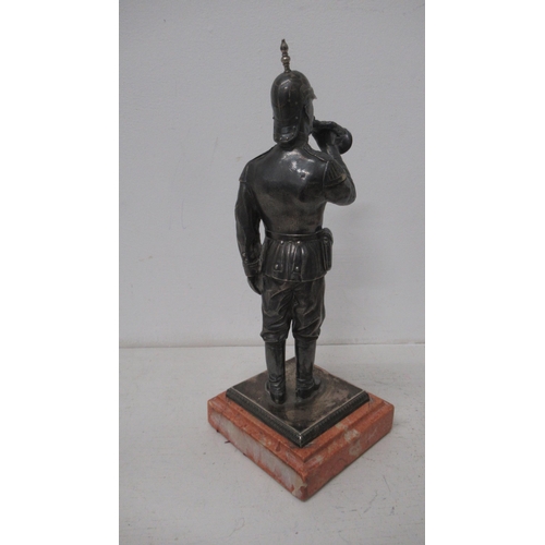 301 - A silver (tested) figure of a soldier with bugle on stone base - 27cm