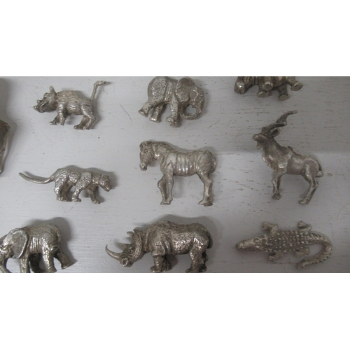 306 - A collection of silver (tested) figures of animals (14) together with 2 x silver hallmarked napkin r... 