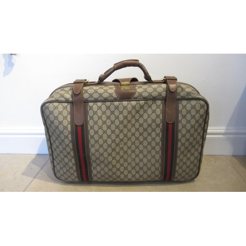 359 - A vintage Gucci suitcase with Gucci monogram throughout with leather straps - 60cm x 40cm