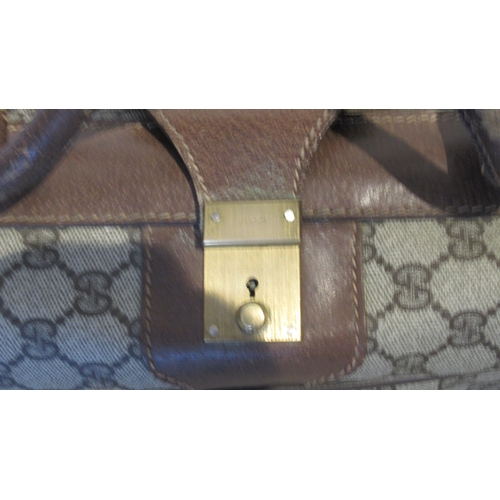 359 - A vintage Gucci suitcase with Gucci monogram throughout with leather straps - 60cm x 40cm