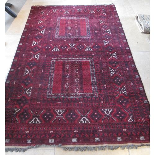 489 - An Eastern hand knotted red ground rug - 150cm x 255cm