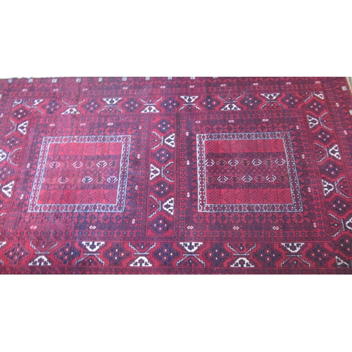 489 - An Eastern hand knotted red ground rug - 150cm x 255cm