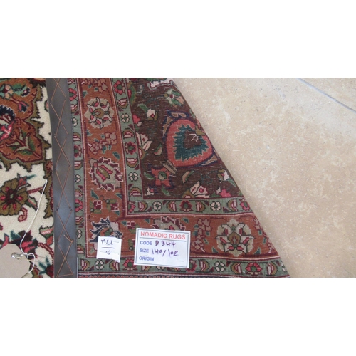 496A - A hand knotted woollen Tabriz rug - 1.40m x 1.02m