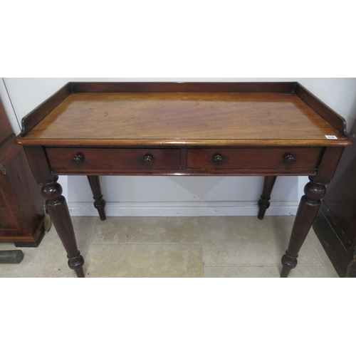 516 - A 19th century mahogany side table / desk with two drawers on turned legs, good patina, 105cm wide x... 