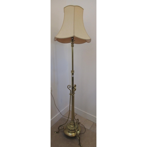 536 - A good quality brass lamp with adjustable height on three outswept legs, 190cm high