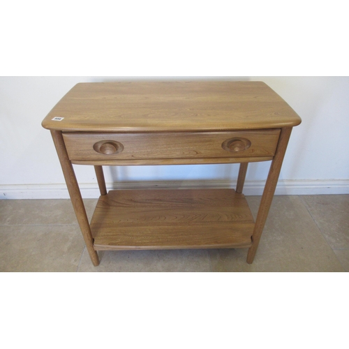 556 - An Ercol Blonde side table with a drawer - Width 80cm x Height 73cm x Depth 40cm