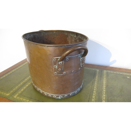 564 - A hand hammered copper log bucket, riveted with twin handles, of oval shape with good patina - 55cm ... 