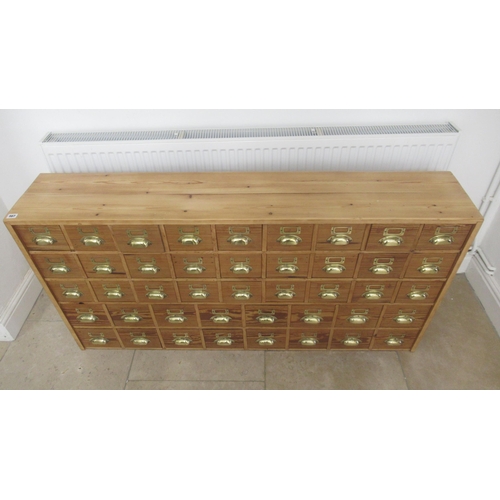 567 - A 19th century pine seed cabinet with 45 drawers with brass cup handles, well made with dovetailed d... 