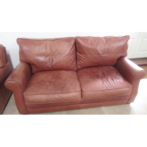 568 - A Collins and Hayes tan leather settee and matching armchair