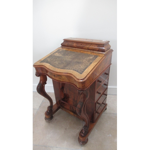 569 - A Victorian burr walnut Davenport with four drawers, sloped writing space and top mounted storage un... 