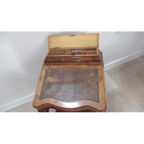 569 - A Victorian burr walnut Davenport with four drawers, sloped writing space and top mounted storage un... 