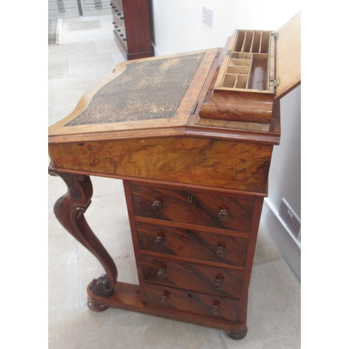 569 - A Victorian burr walnut Davenport with four drawers, sloped writing space and top mounted storage un... 