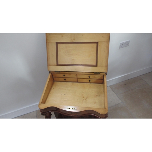 569 - A Victorian burr walnut Davenport with four drawers, sloped writing space and top mounted storage un... 