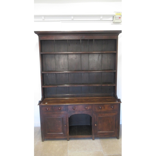 575 - A good 18th/19th century oak dresser - the top with three shelves and wide back boards over the pot ... 