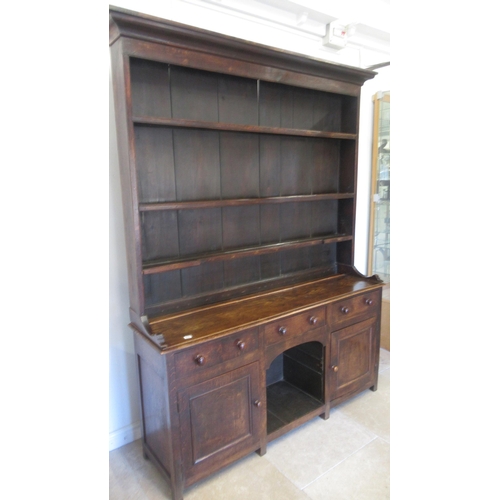 575 - A good 18th/19th century oak dresser - the top with three shelves and wide back boards over the pot ... 