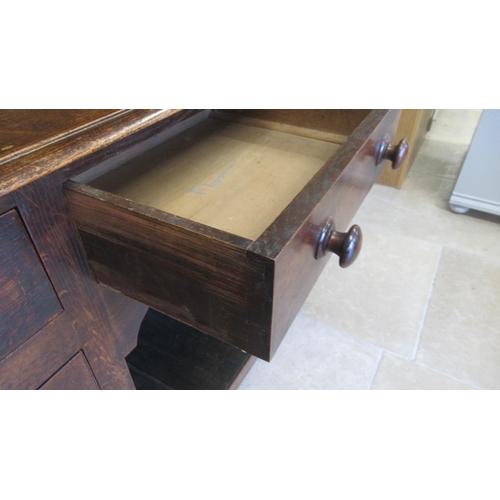 575 - A good 18th/19th century oak dresser - the top with three shelves and wide back boards over the pot ... 