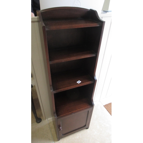 586 - A 20th century oak waterfall open bookcase with lower cupboard - Height 115cm x Width 36cm