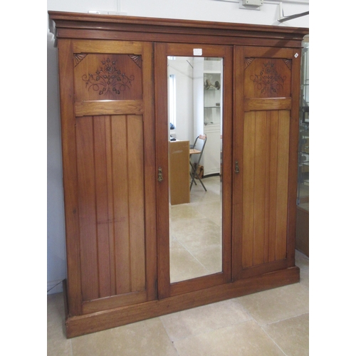 592 - A circa 1900's satin walnut wardrobe with three doors and an interior with a linen press over four d... 