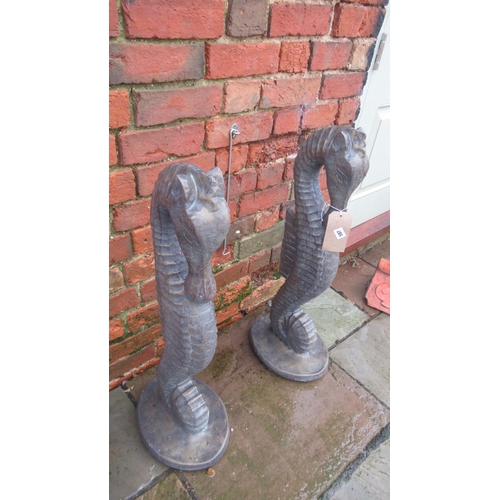 597 - A pair of cast stone seahorses with a bronze finish - Height 79cm x Width 28cm