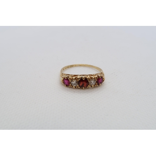 69 - An 18ct yellow gold (hallmarked) five stone bridge ring with ruby, diamond and red garnet - ring siz... 